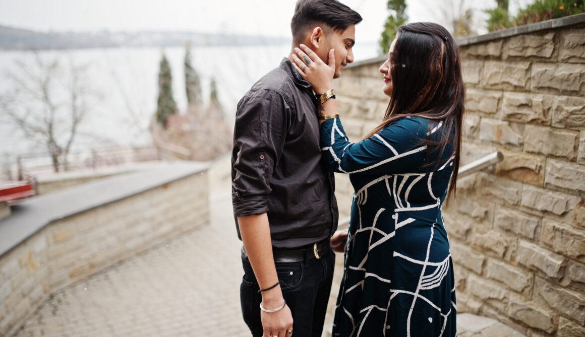 Love story of indian couple posed outdoor.